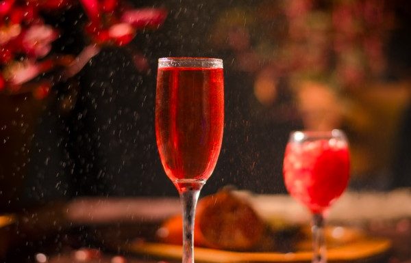 wine glasses with red juice on the wooden round