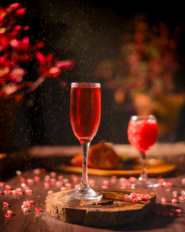 wine glasses with red juice on the wooden round