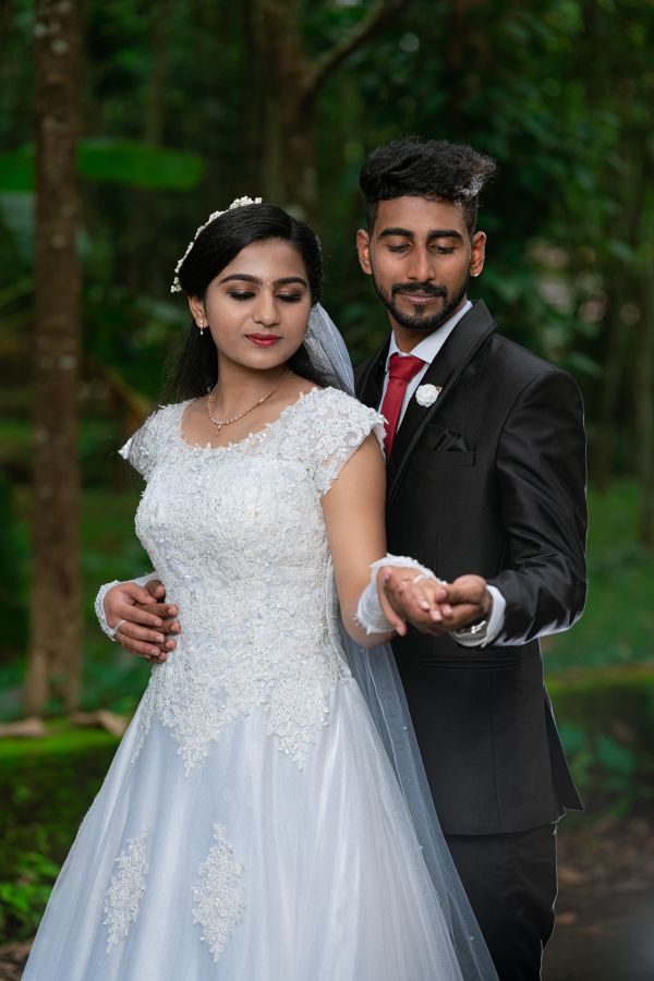 Groom-and-bride-standing -by-holding-their-hands-together