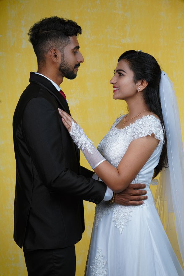 Groom-and-bride-standing-by-looking-each-other