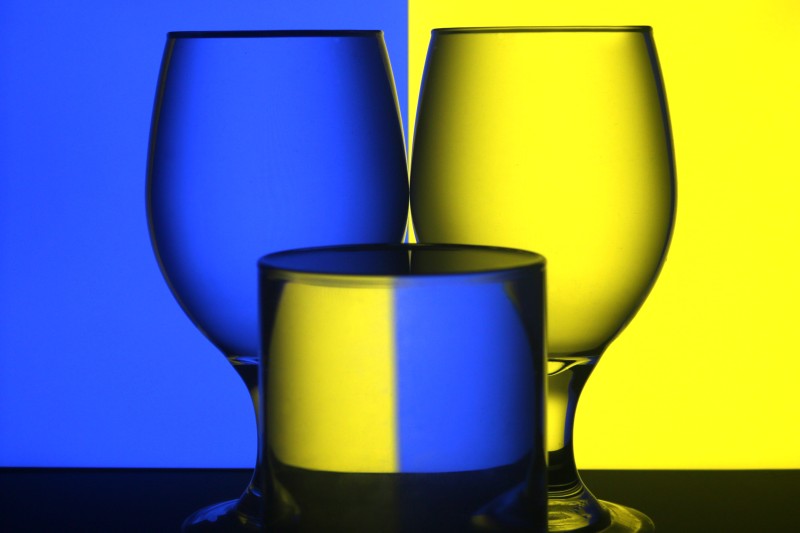 three glasses on yellow and blue background