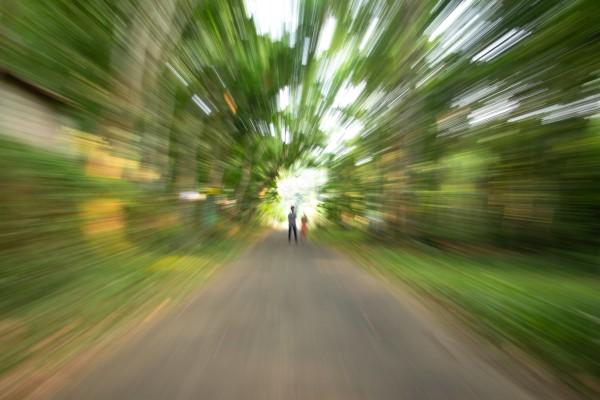 two persons standing middle of the road