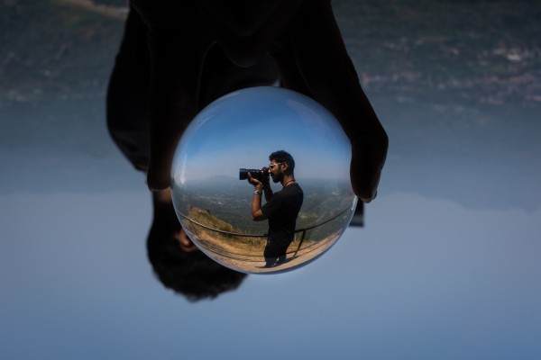 one person holded lens ball and a man inside it