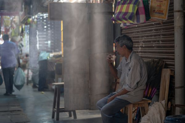 an old man drinking tea