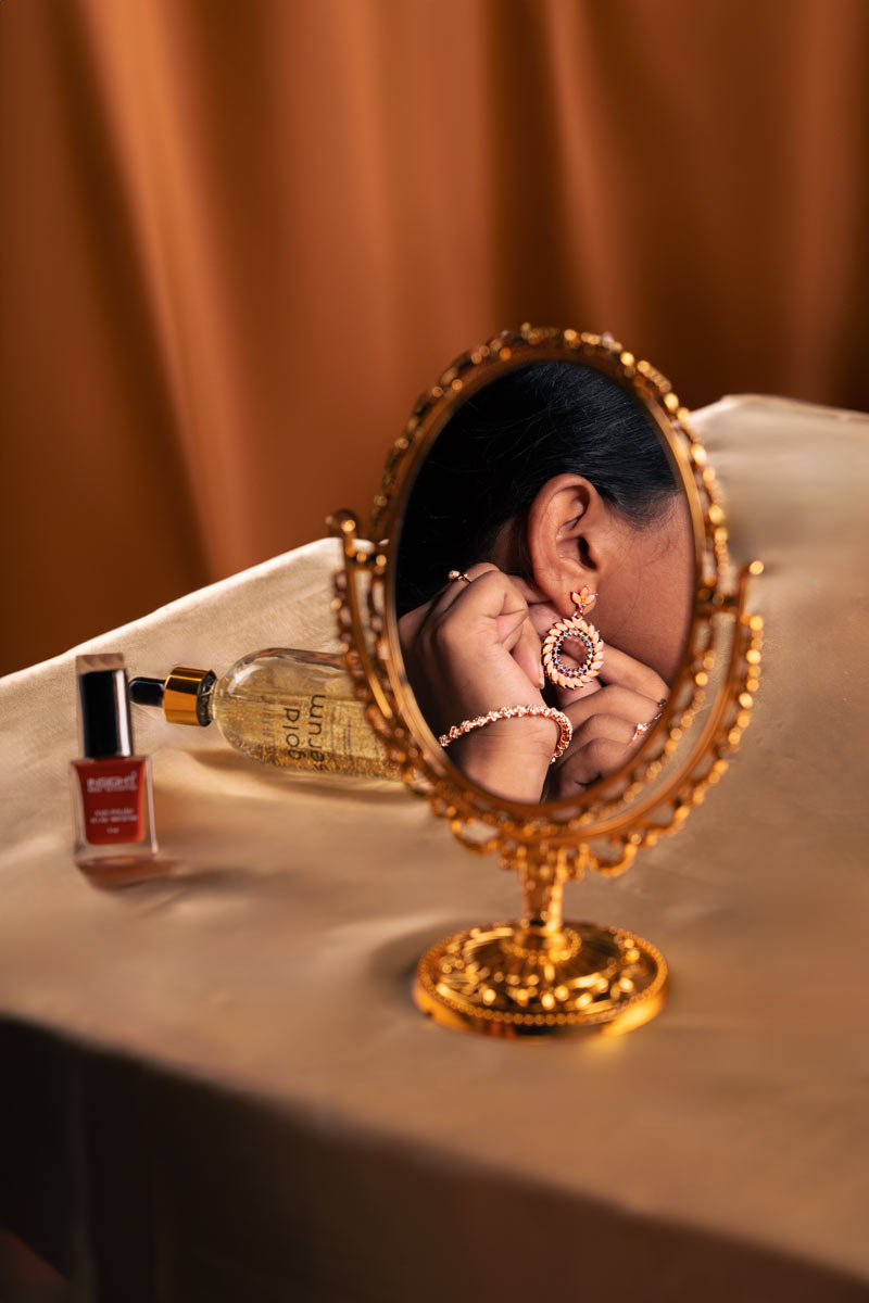 Earrings and bangle seen in mirror
