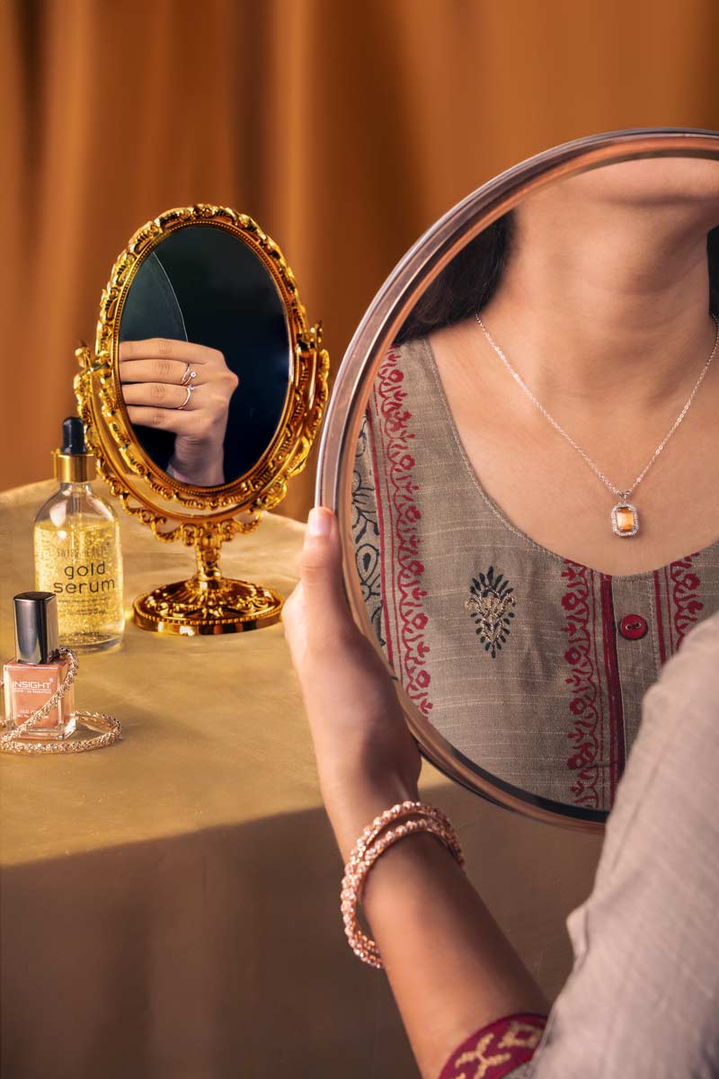 necklace and rings reflected in mirror