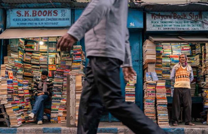 A man walking through book stores that refuge for readers