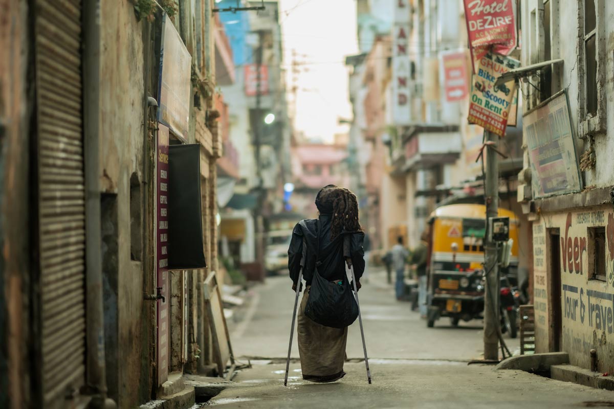 a man is walking with supportive sticks