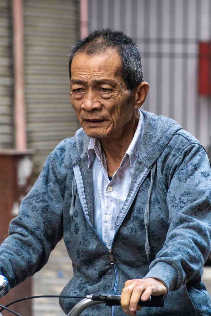 old aged man riding a bicycle