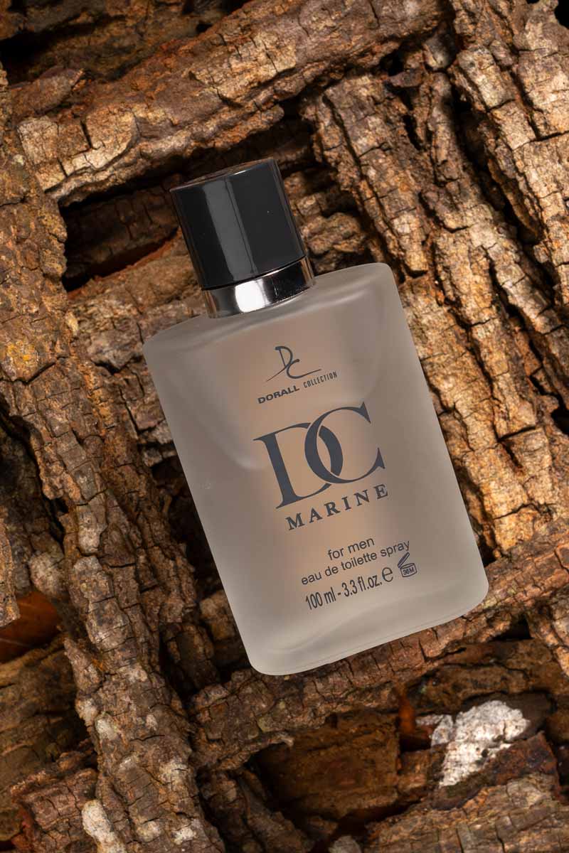 A dc marine perfume on a wooden texture .