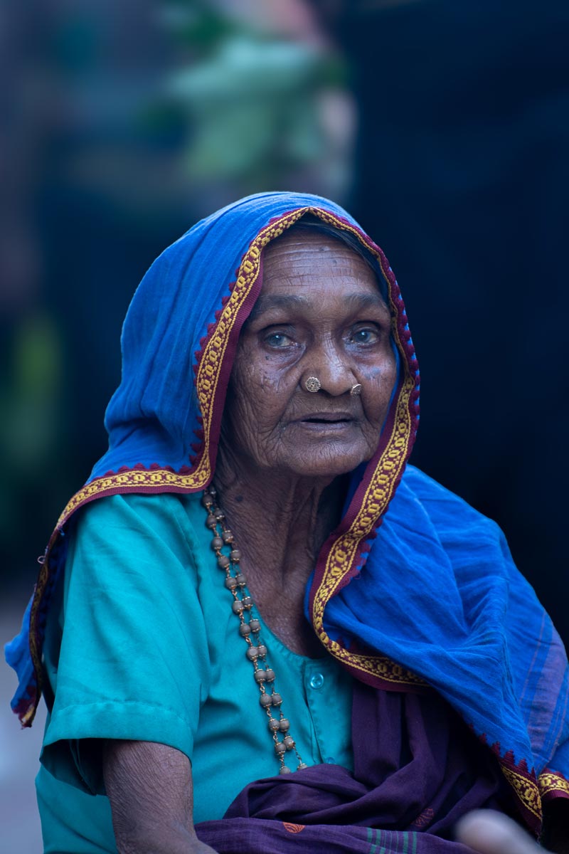 A aged mother looking towards the camera.