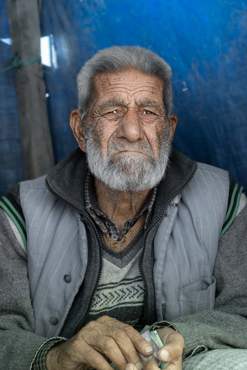 Individual Sitting in the center of Srinagar’s crowded market