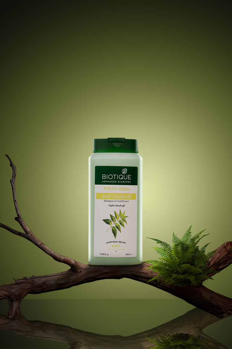 Natural shampoo placed on a wooden branch