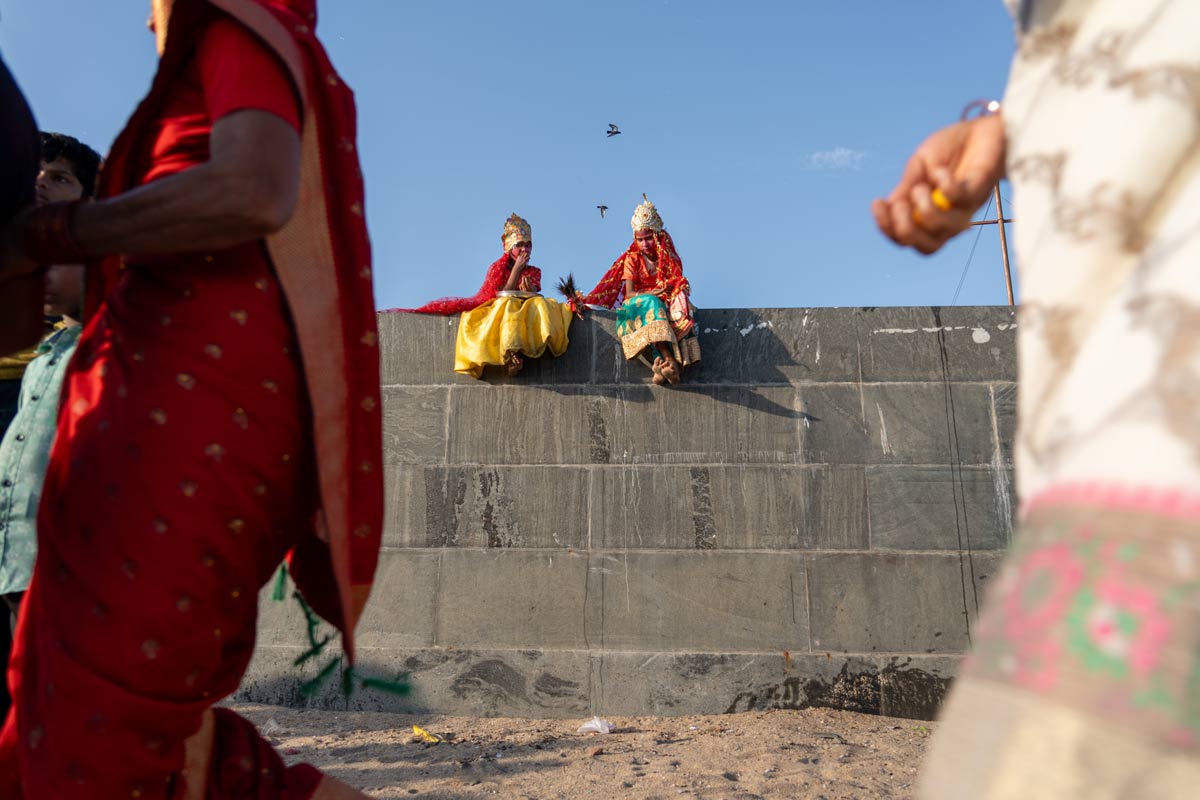 two children sitting on a wall