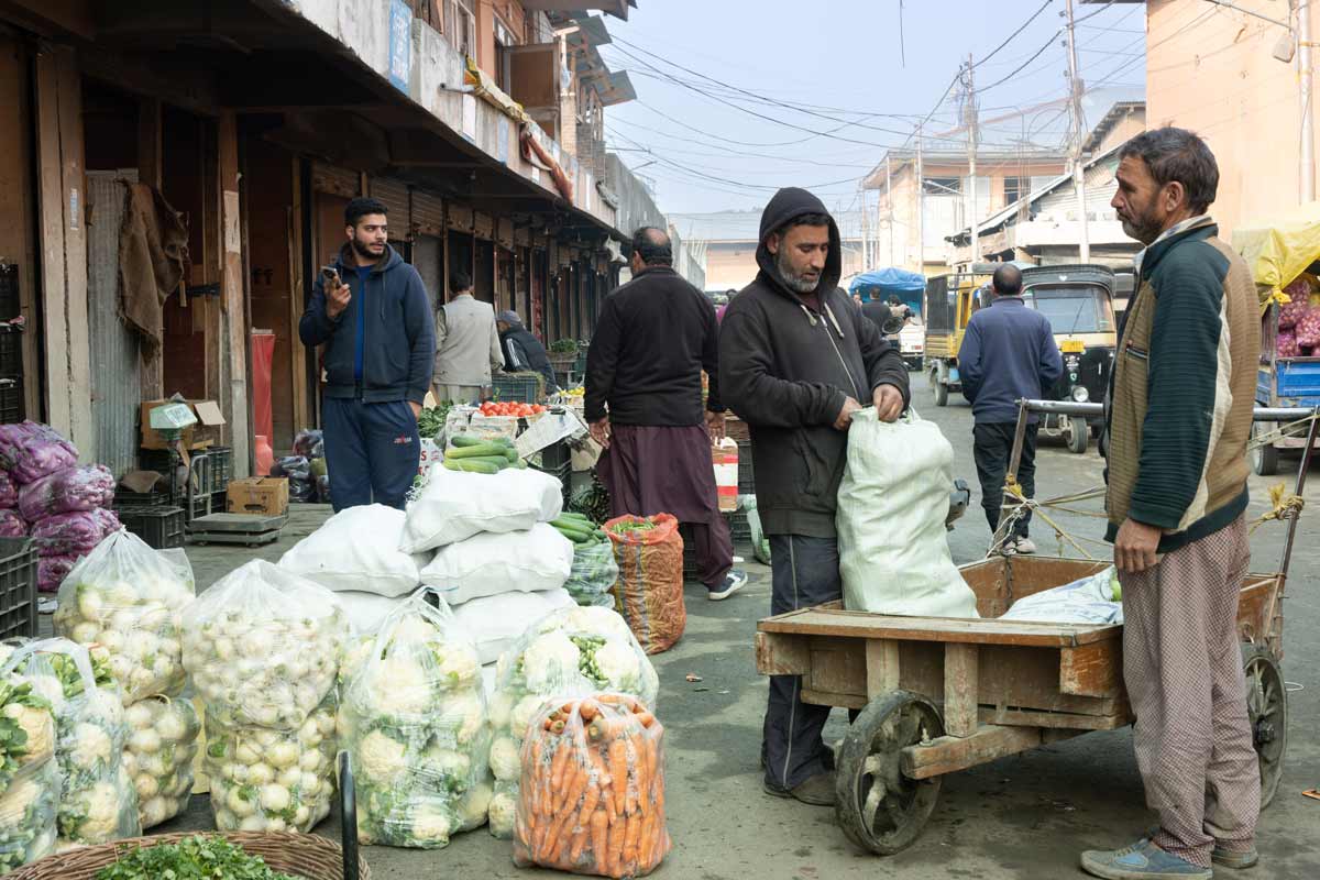 A Man opening the vegetables from sack for sale