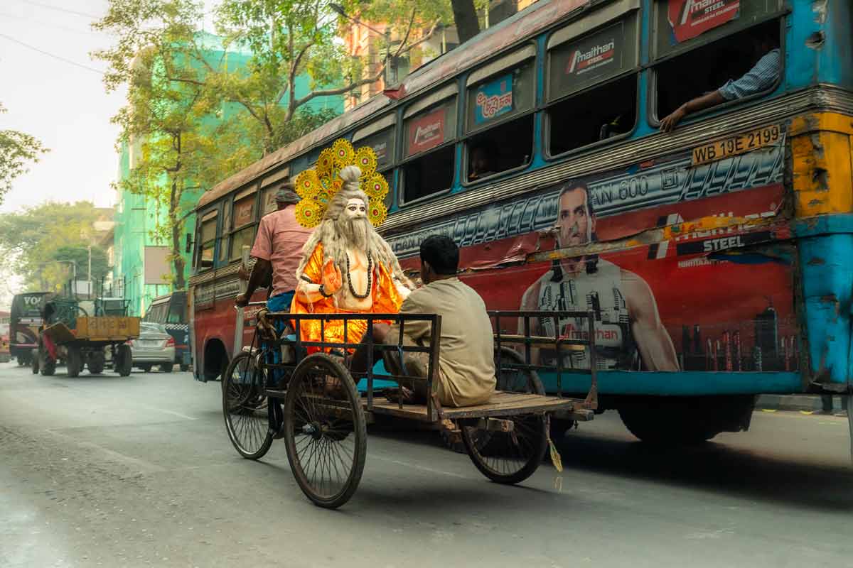 men taking idol in tricycle