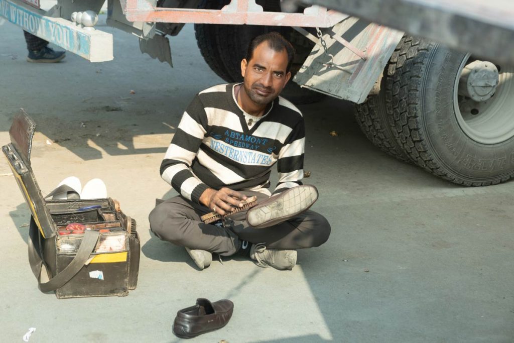 A man polishing shoes in streets