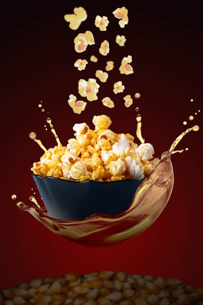spicy popcorn falling to the bowl and its looks levitating.