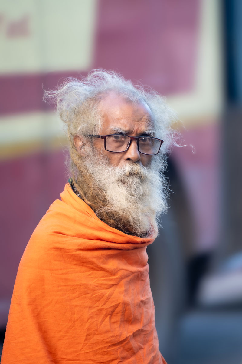 A aged guy crossing the road.