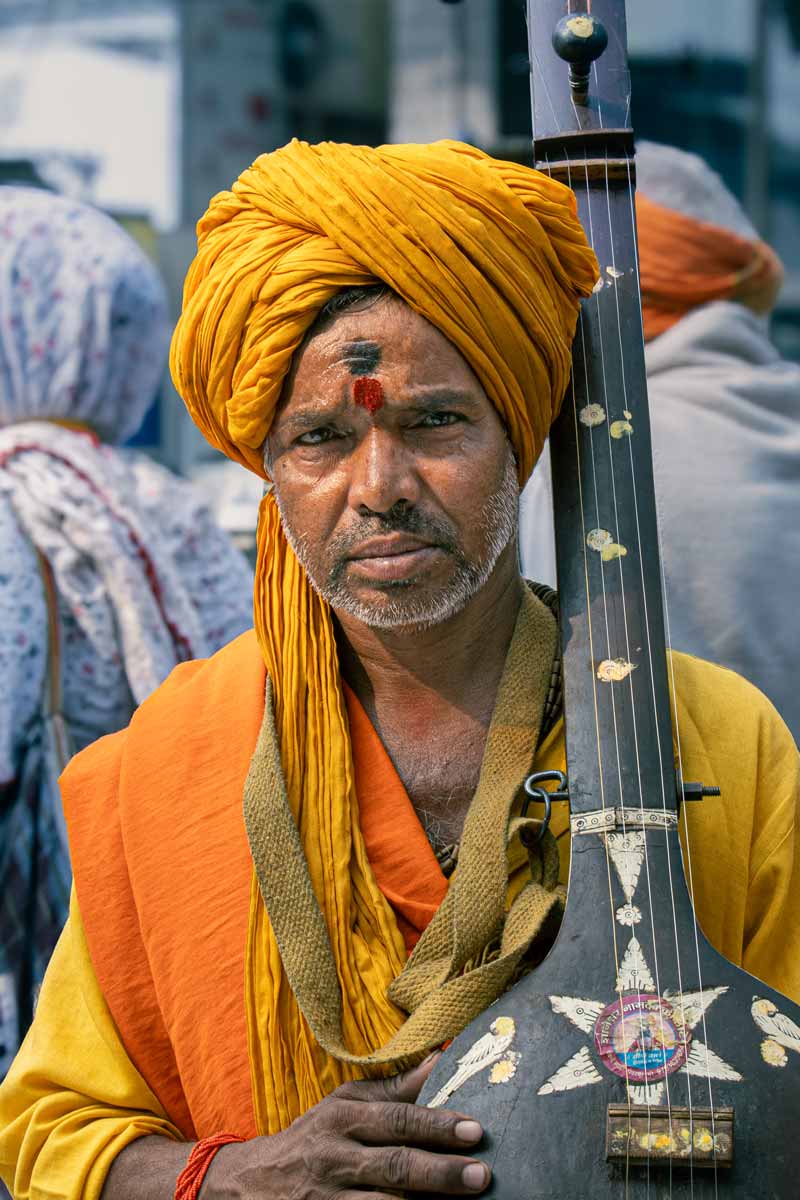 a man holding a traditional sitar