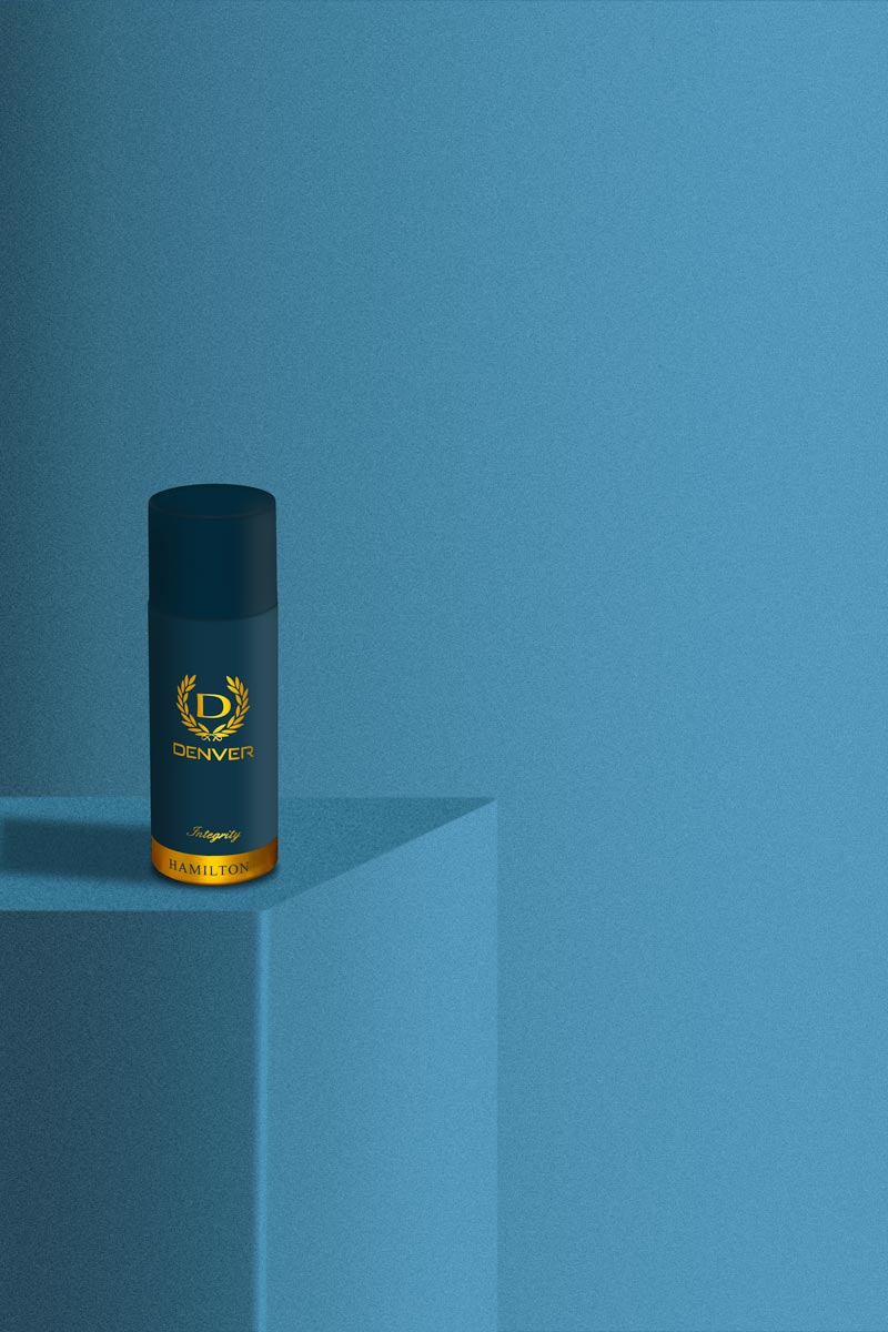 blue and gold coloured spray bottle on a blue background
