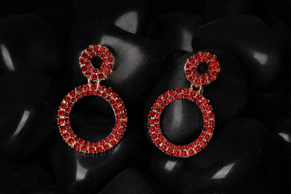 ear ring full of red diamonds