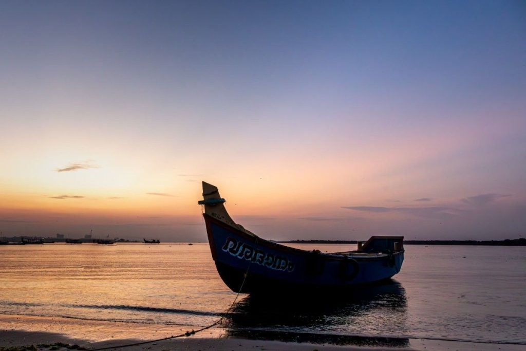 A silhouette of a boat before sunrise