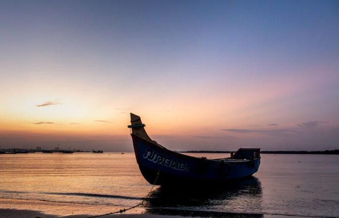 A silhouette of a boat before sunrise