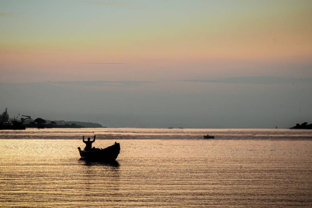 A man on a boat doing prayer.