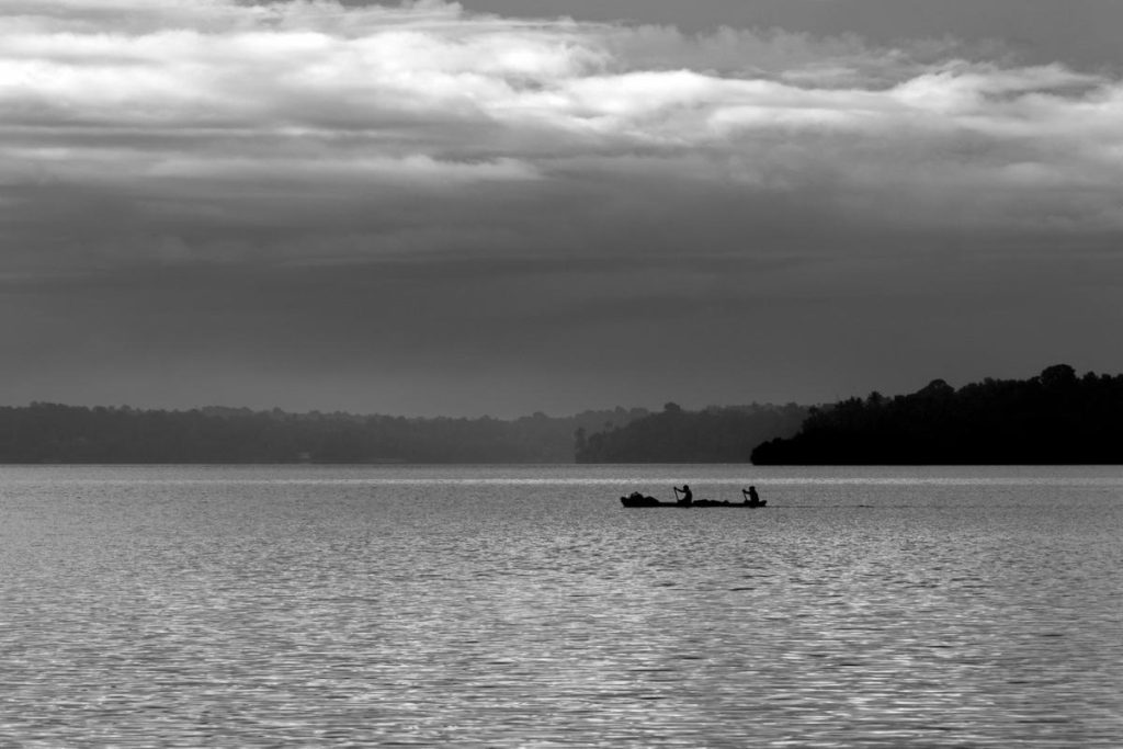  A calm  backwaters and one boat in the scene.