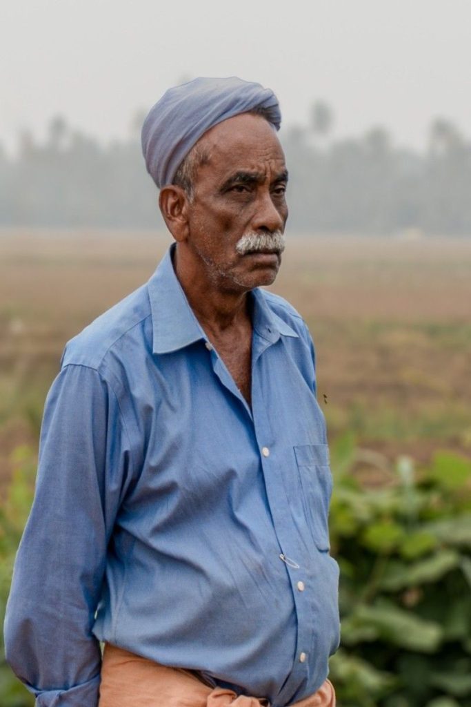 An old man with sky blue turban towel