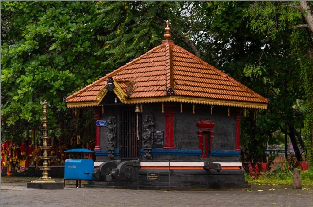 A small temple in between greenery.