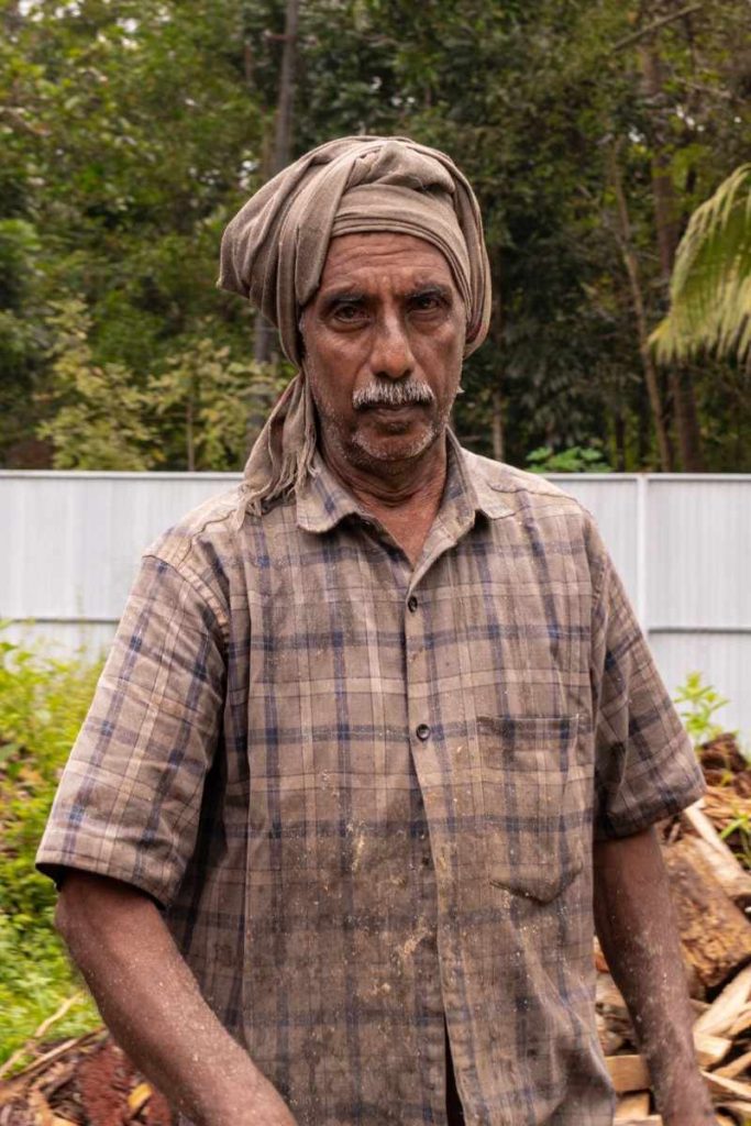 An old working man wearing the same colour shirt and turban