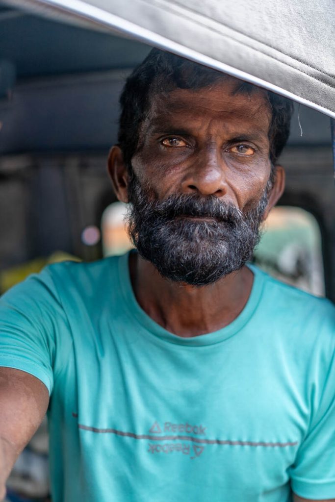 a common man with humble presence sitting in an auto.