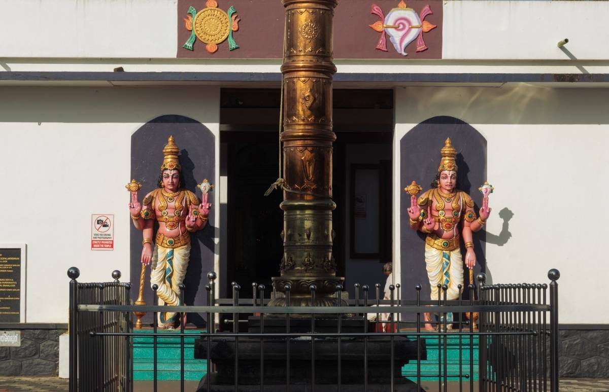 Front view of vaishnava temple with 2 sculptures in front.