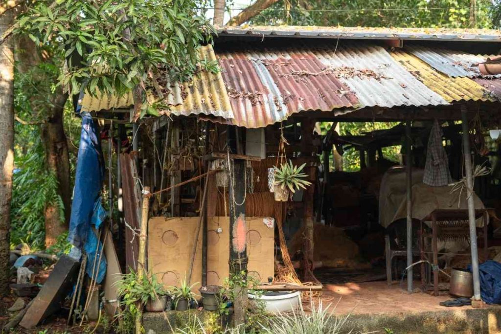 A rustic coir factory with looms and rope bundles near the backwaters.