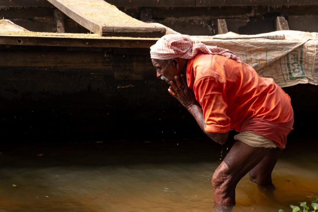 Cooling Off A worker splashes water on his face.