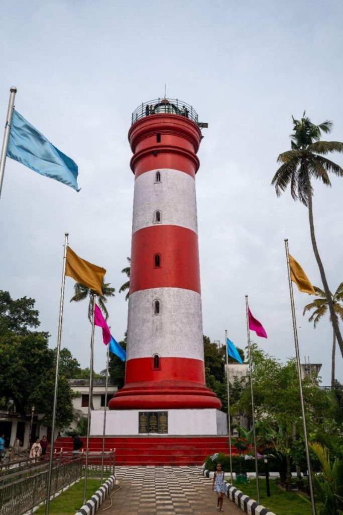 Lighthouse – A red and white lighthouse with flags.