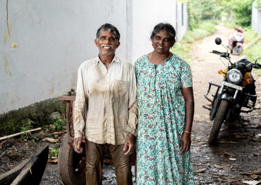 Together A smiling couple stands in a rural setting