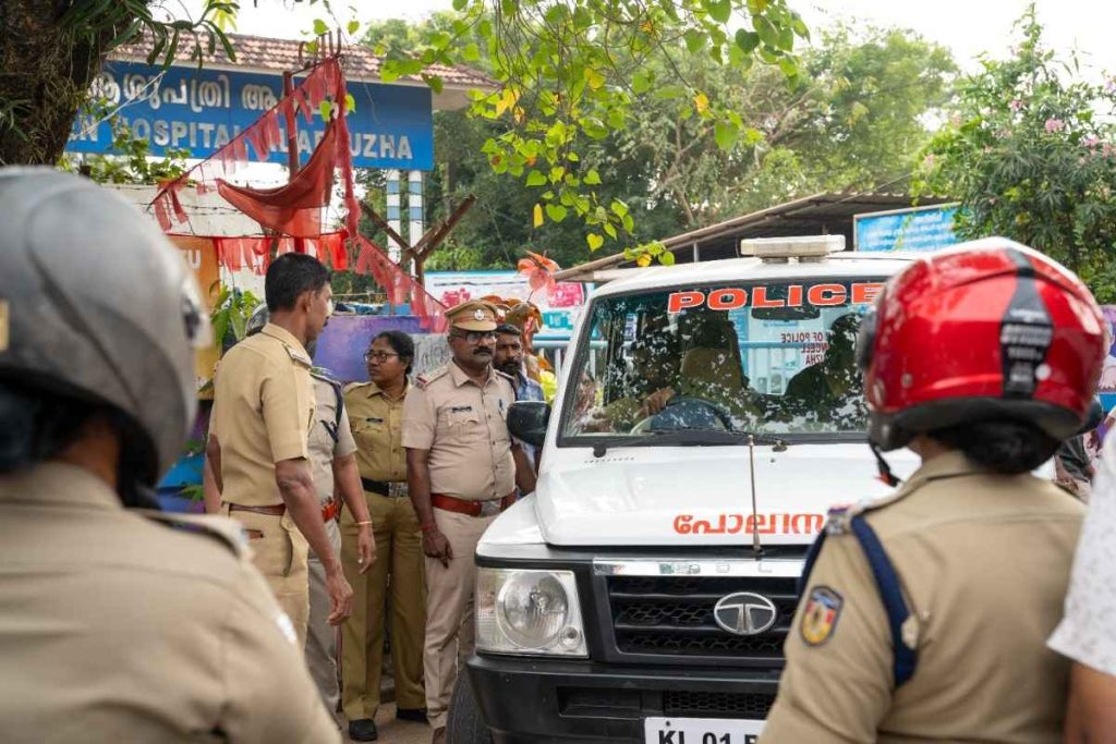 Police presence gather near a patrol vehicle amid a tense situation.