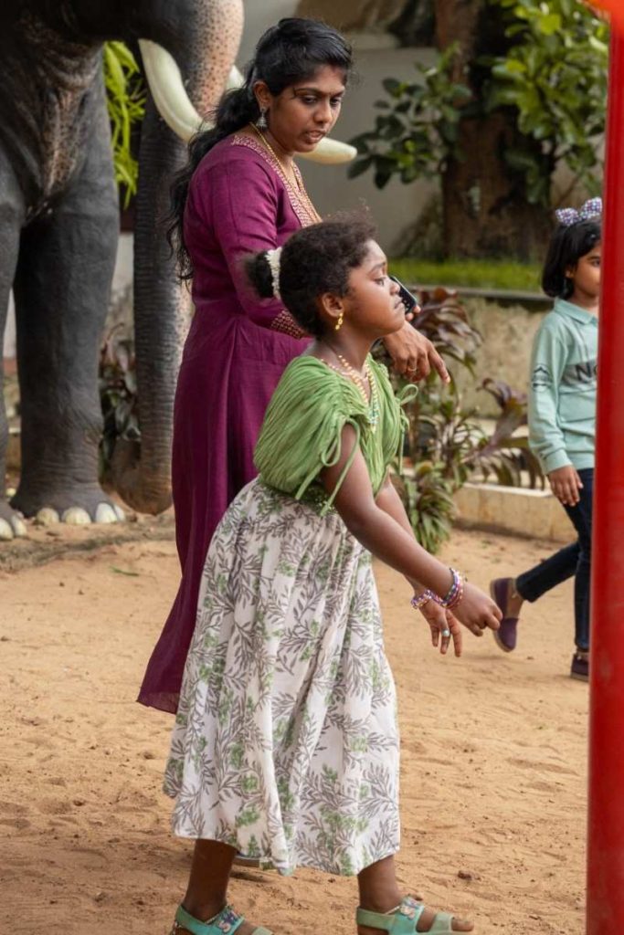 Fleeting Tears A girl in a green dress looks upset while playing.