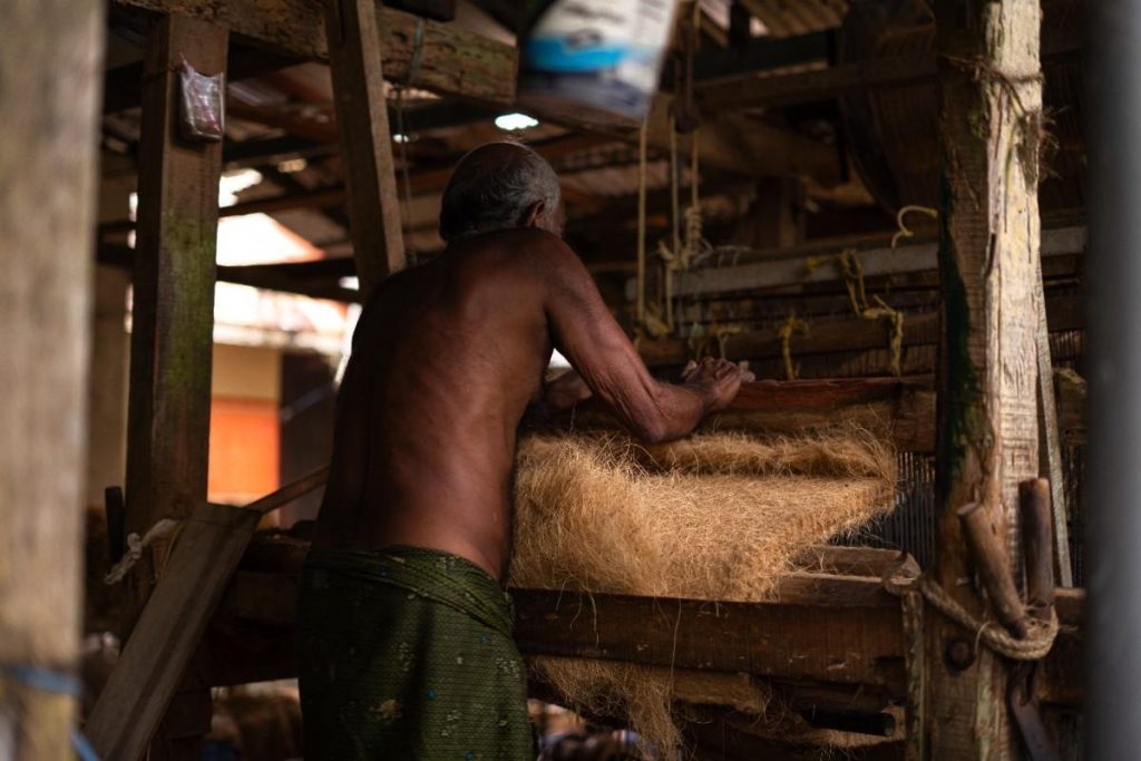 Machine Mastery Elderly weaver crafting coconut fiber ropes.