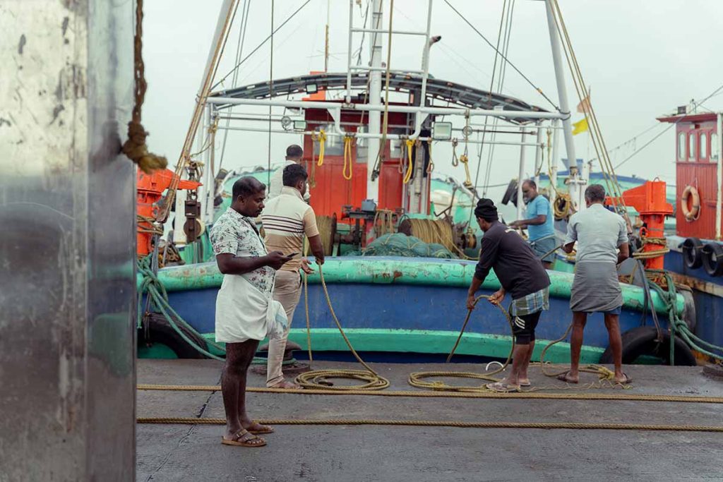 Fishermen docking the boat.