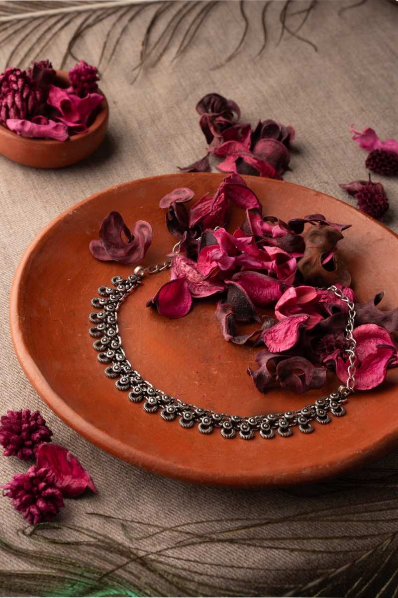 dusky bloom necklace resembling the graceful movement in flowers .