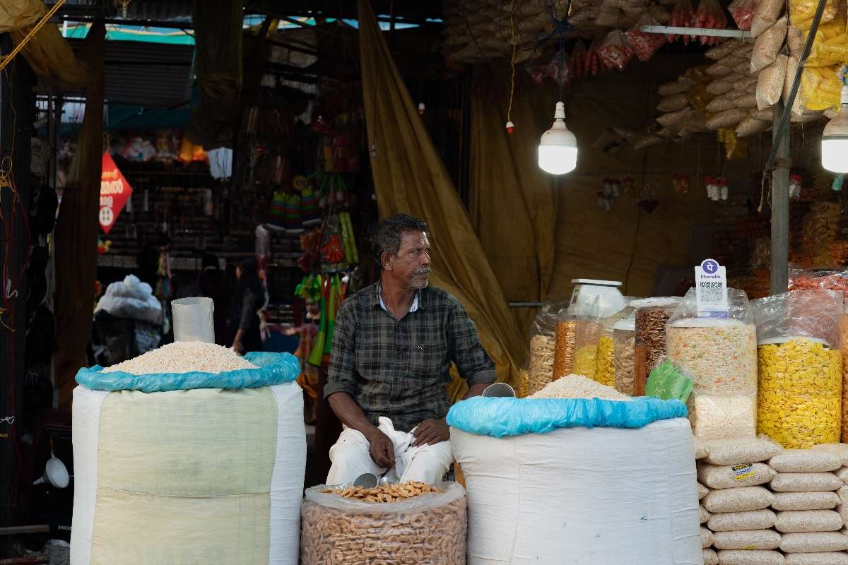 Market hustle around a vendor with grains