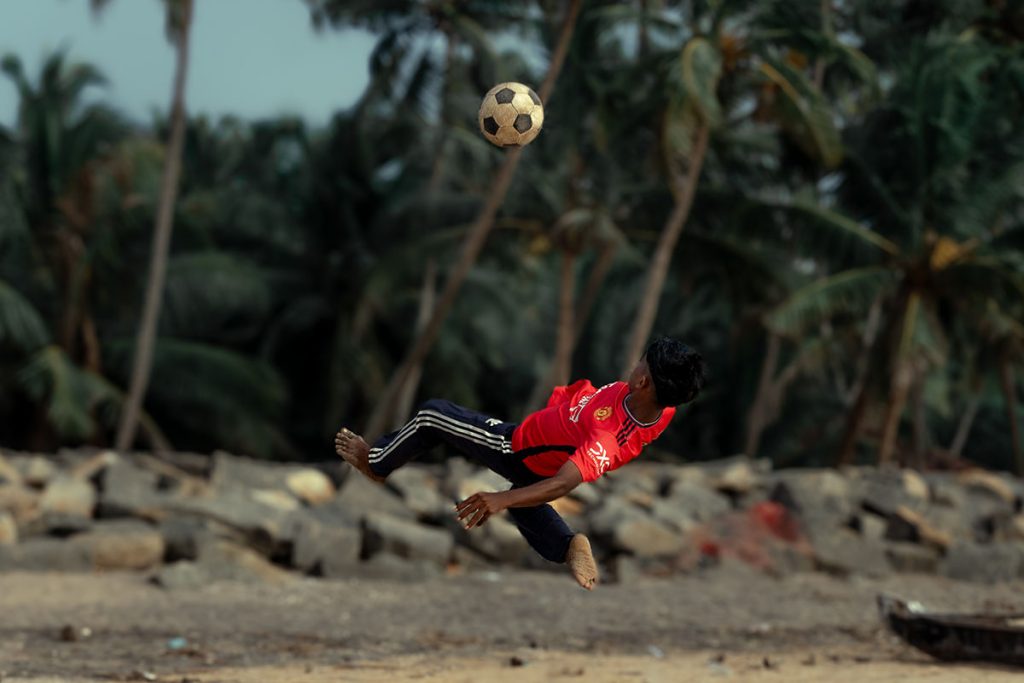 bicycle kick by a kid in beach