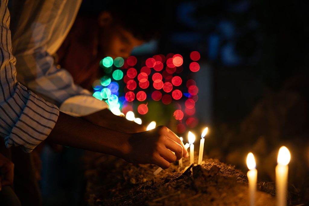 Burning Faith Devotees light candles, their burning faith glowing