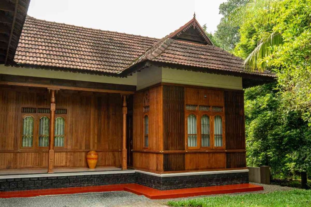 Traditional Kerala house side view with wooden structure.