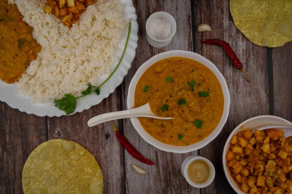 Comfort Feast with dal, rice, and crispy potatoes.