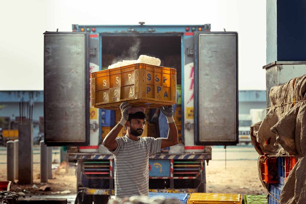 A worker carrying a cool load of blocks.